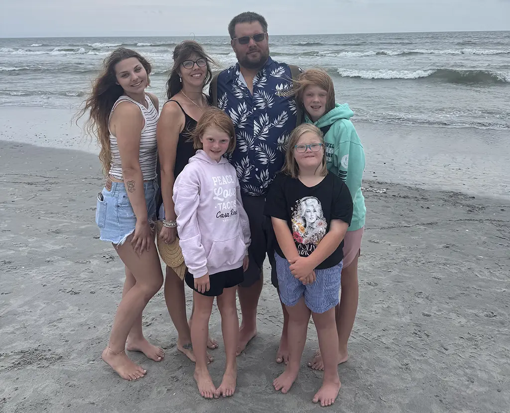 The black diamond farms family on a beach